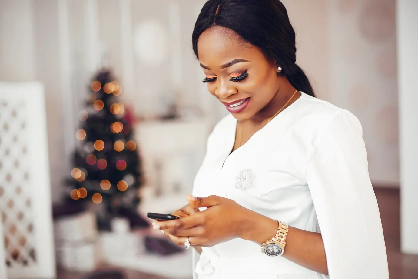 Ein elegantes schwarzes Mädchen in einem Zimmer an Weihnachten.